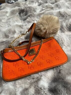 Dooney & Bourke Orange Signature Logo Wristlet with Gold Chain and Pom